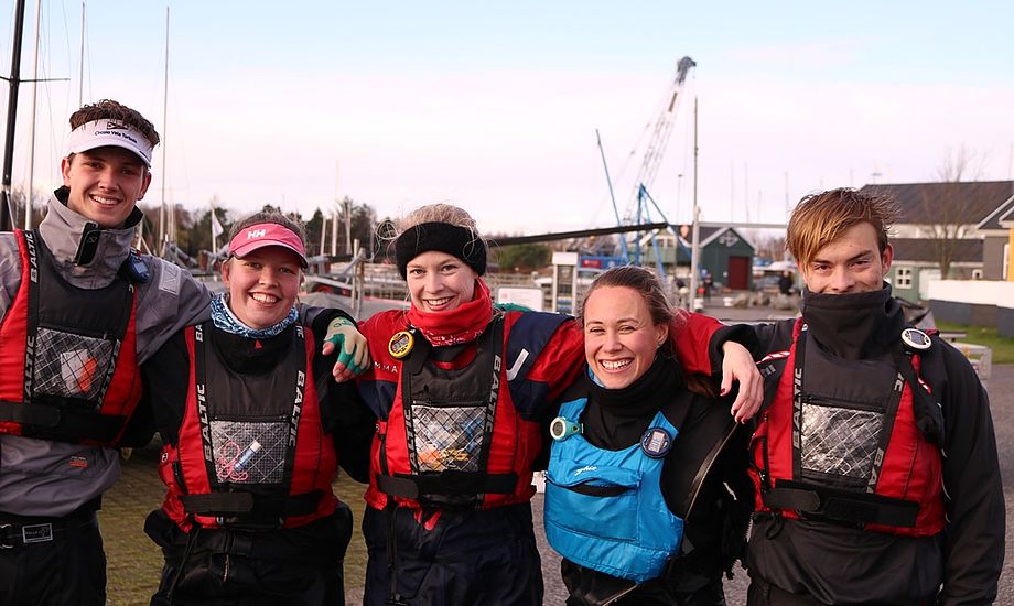 Der var stadig smil på læberne hos sejlerne efter en lang og kold dag på vandet. Fra Venstre: Nikolai Tiedemann, Maria Ravn, Julie Skovbo, Marisa Roch og Sophus Jarvig.  Foto: Rune Cramer.